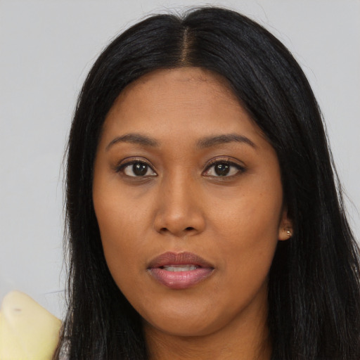 Joyful asian young-adult female with long  black hair and brown eyes