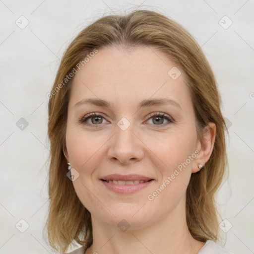 Joyful white young-adult female with medium  brown hair and green eyes