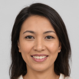 Joyful white young-adult female with long  brown hair and brown eyes