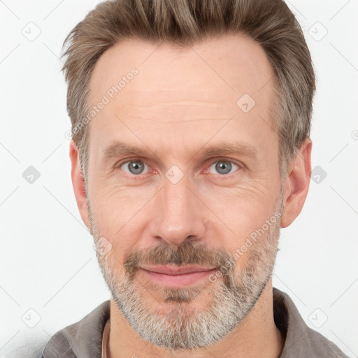 Joyful white adult male with short  brown hair and grey eyes