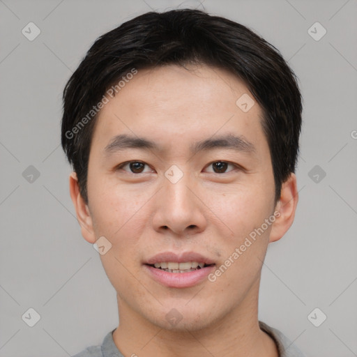 Joyful asian young-adult male with short  brown hair and brown eyes