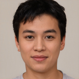 Joyful asian young-adult male with short  black hair and brown eyes