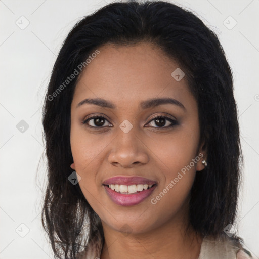 Joyful black young-adult female with long  black hair and brown eyes