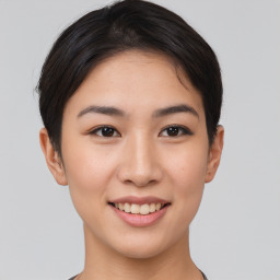 Joyful asian young-adult female with short  brown hair and brown eyes