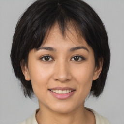 Joyful asian young-adult female with medium  brown hair and brown eyes