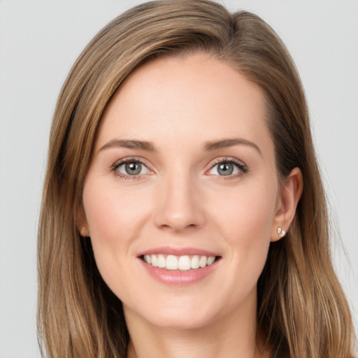 Joyful white young-adult female with long  brown hair and grey eyes