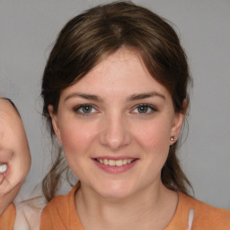 Joyful white young-adult female with medium  brown hair and brown eyes