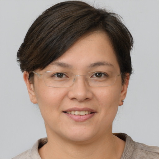 Joyful white adult female with short  brown hair and brown eyes
