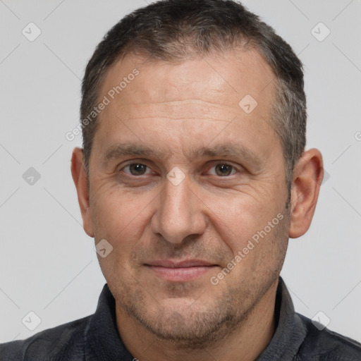 Joyful white adult male with short  brown hair and brown eyes