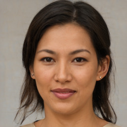 Joyful latino young-adult female with medium  brown hair and brown eyes