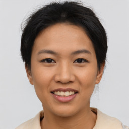 Joyful asian young-adult female with short  brown hair and brown eyes