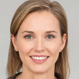 Joyful white young-adult female with long  brown hair and blue eyes