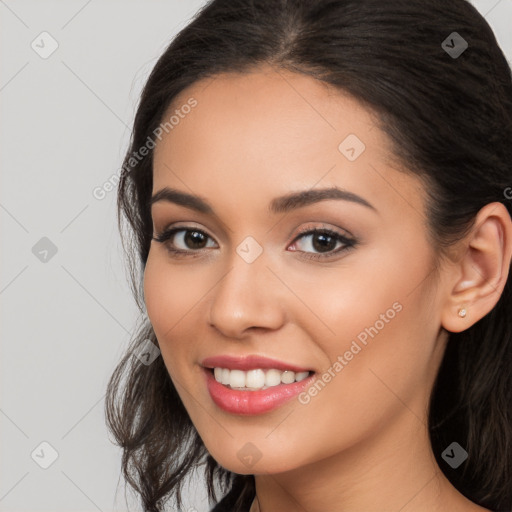 Joyful latino young-adult female with long  brown hair and brown eyes