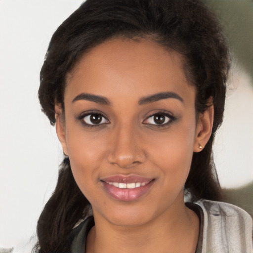 Joyful latino young-adult female with long  brown hair and brown eyes