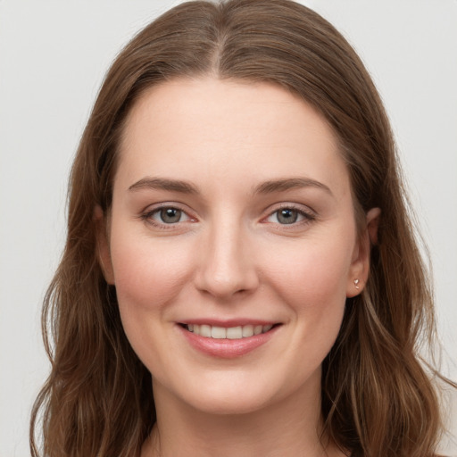 Joyful white young-adult female with long  brown hair and grey eyes