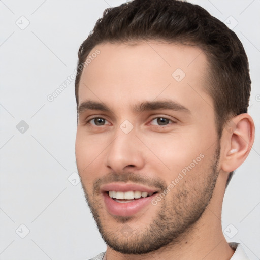 Joyful white young-adult male with short  brown hair and brown eyes