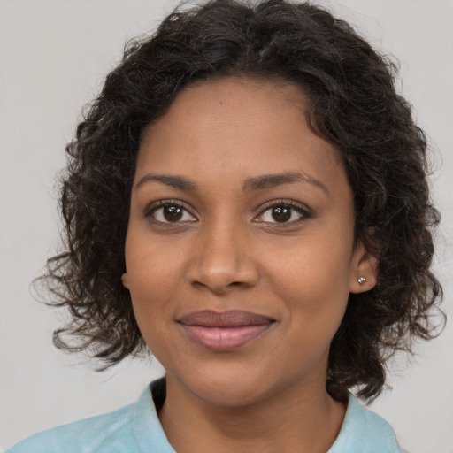 Joyful black young-adult female with medium  brown hair and brown eyes