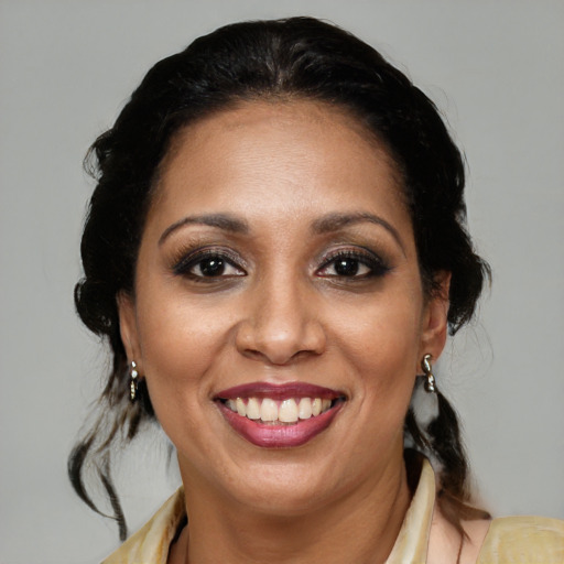 Joyful latino adult female with medium  brown hair and brown eyes