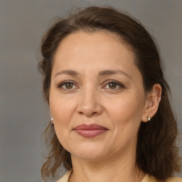 Joyful white adult female with medium  brown hair and brown eyes