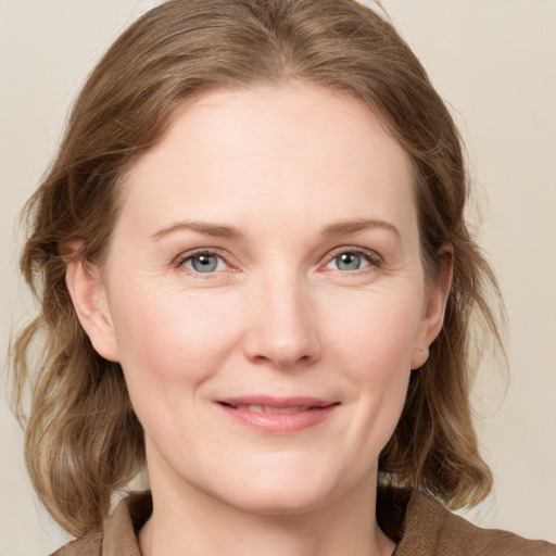 Joyful white young-adult female with medium  brown hair and blue eyes