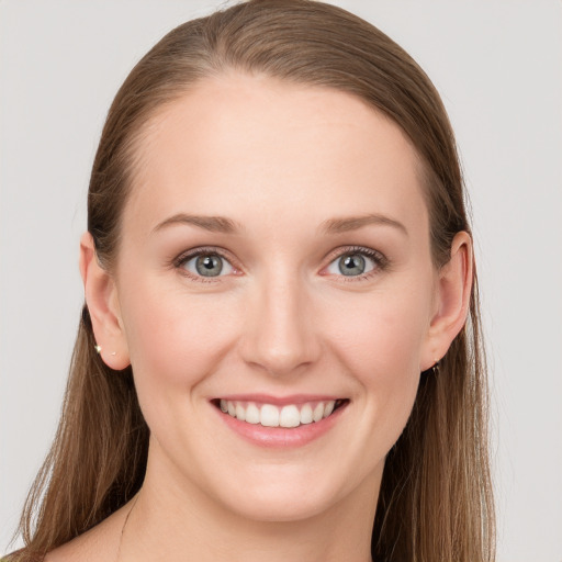 Joyful white young-adult female with long  brown hair and blue eyes