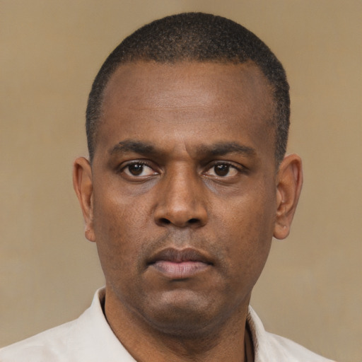Neutral black adult male with short  black hair and brown eyes