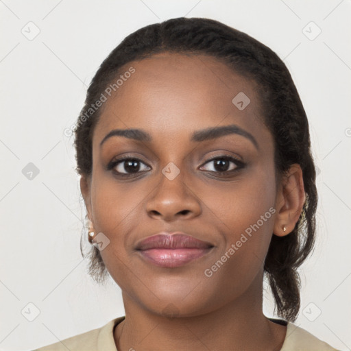 Joyful black young-adult female with long  black hair and brown eyes