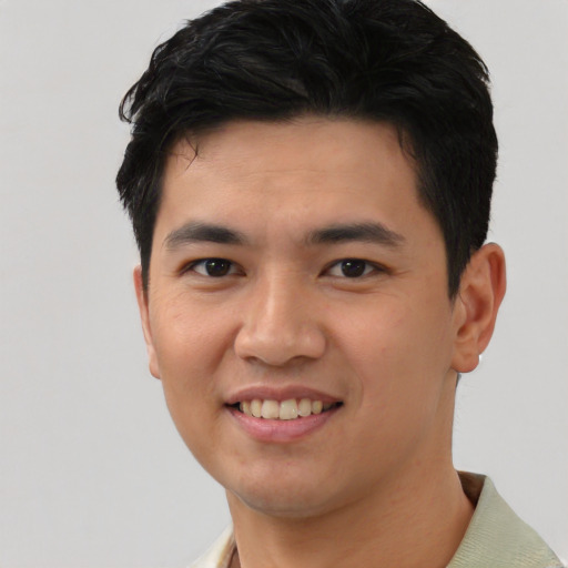 Joyful asian young-adult male with short  black hair and brown eyes