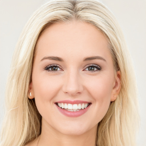 Joyful white young-adult female with long  brown hair and blue eyes