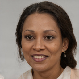 Joyful white adult female with medium  brown hair and brown eyes