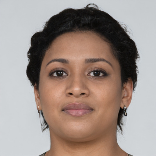 Joyful latino young-adult female with short  black hair and brown eyes