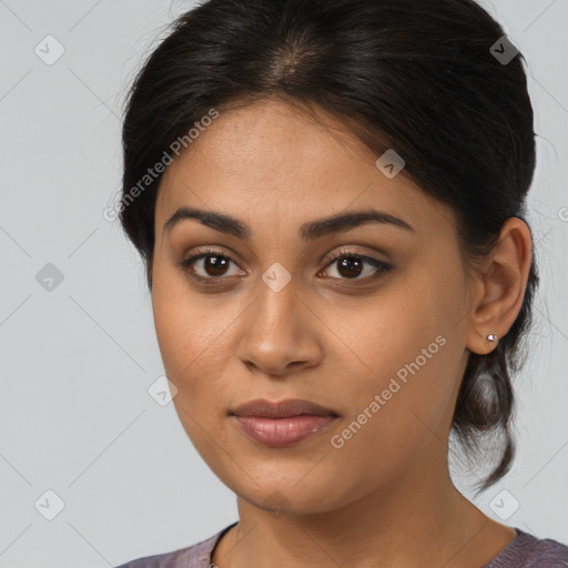 Joyful latino young-adult female with medium  brown hair and brown eyes