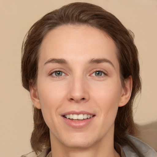 Joyful white young-adult female with medium  brown hair and brown eyes