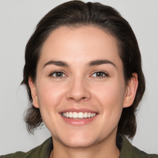 Joyful white young-adult female with medium  brown hair and brown eyes