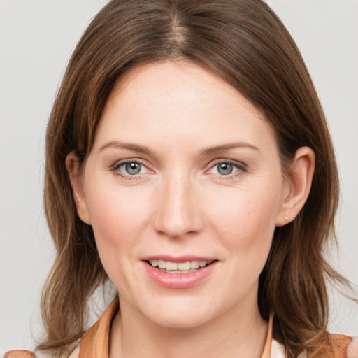 Joyful white young-adult female with medium  brown hair and grey eyes