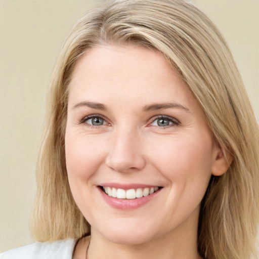 Joyful white young-adult female with long  brown hair and green eyes