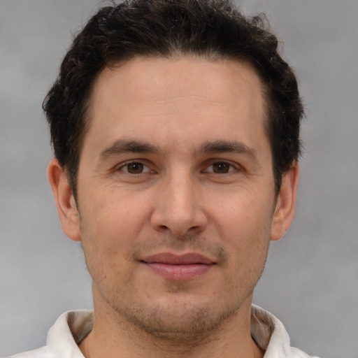 Joyful white adult male with short  brown hair and brown eyes