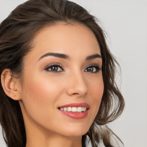 Joyful white young-adult female with long  brown hair and brown eyes