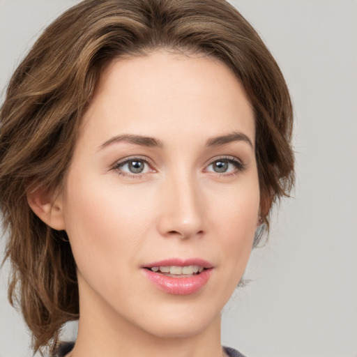 Joyful white young-adult female with medium  brown hair and green eyes