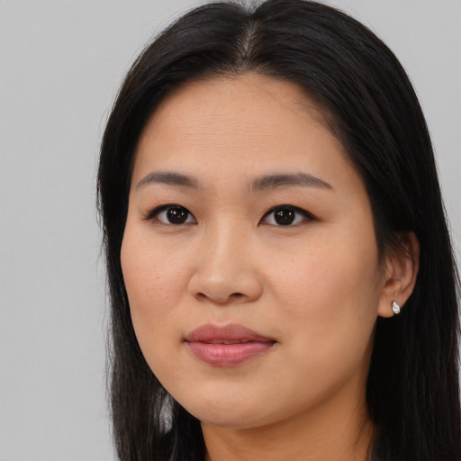 Joyful asian young-adult female with long  brown hair and brown eyes