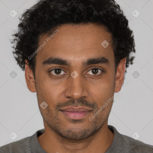 Joyful black young-adult male with short  brown hair and brown eyes