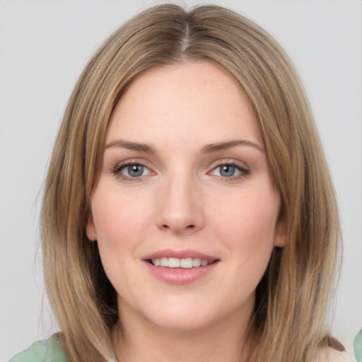 Joyful white young-adult female with medium  brown hair and green eyes