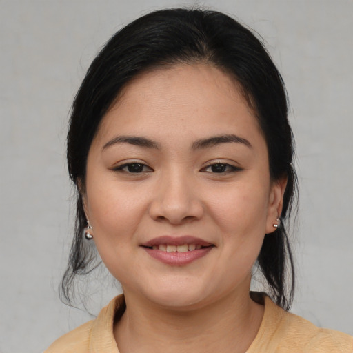 Joyful asian young-adult female with medium  brown hair and brown eyes