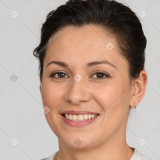 Joyful white young-adult female with short  brown hair and brown eyes