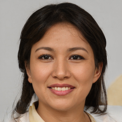 Joyful asian young-adult female with medium  brown hair and brown eyes