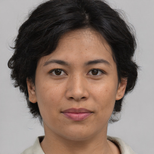 Joyful asian adult female with medium  brown hair and brown eyes