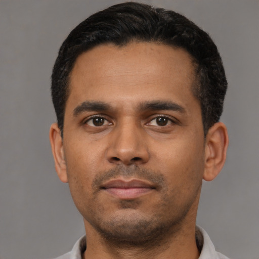 Neutral latino young-adult male with short  black hair and brown eyes