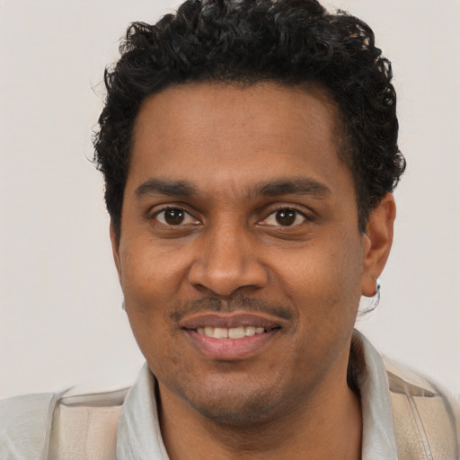 Joyful black young-adult male with short  black hair and brown eyes