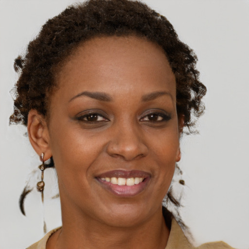 Joyful black adult female with short  brown hair and brown eyes