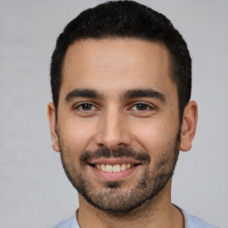 Joyful white young-adult male with short  black hair and brown eyes